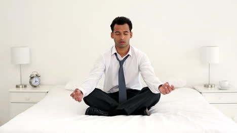 Calm-handsome-businessman-meditating