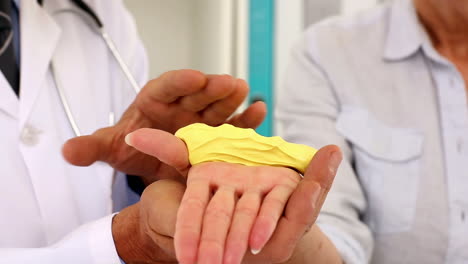 Doctor-explaining-a-foam-gripper-to-his-patient