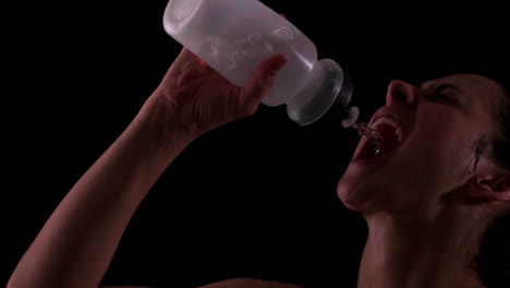Fit-woman-drinking-from-water-bottle