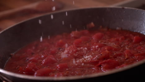 Parmesan-cheese-being-added-to-frying-pan