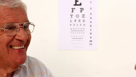 Doctor-fitting-glasses-onto-an-elderly-patient