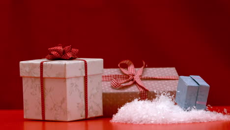 Christmas-present-falling-and-bouncing-on-red-background