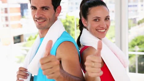 Fit-couple-smiling-at-camera