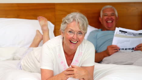 Senior-couple-relaxing-on-bed-