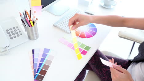 Graphic-designer-looking-at-colour-samples