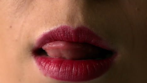 Woman-licking-her-red-lips