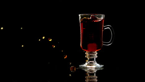 Sugar-cube-falling-into-tea-in-a-glass