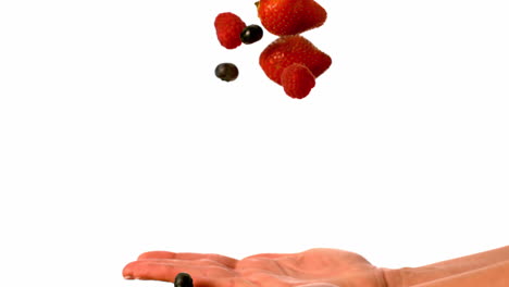 Woman-tossing-berries-on-white-background