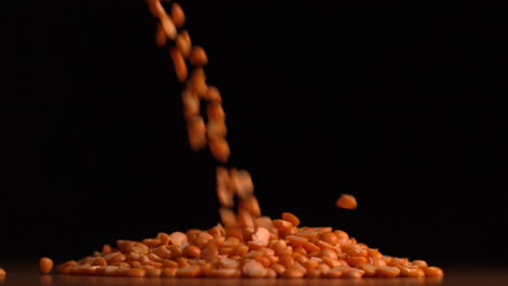 Peanuts-pouring-on-black-background