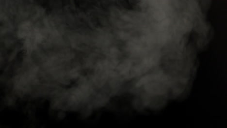 Smoke-blowing-against-black-background