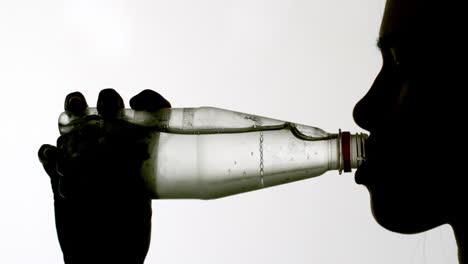 Silhouette-of-woman-drinking-from-bottle