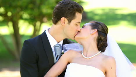 Happy-newlyweds-embracing-each-other-in-the-park