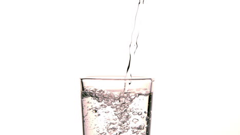 Water-pouring-into-glass-on-white-background