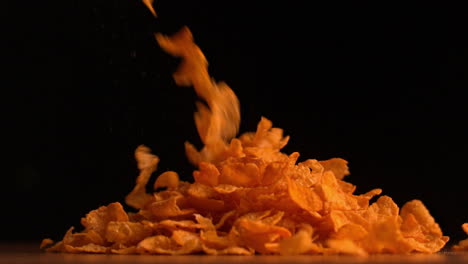 Cereal-flakes-pouring-on-black-background