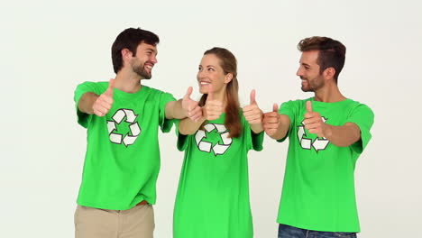 Team-of-environmental-activists-smiling-at-camera-showing-thumbs-up