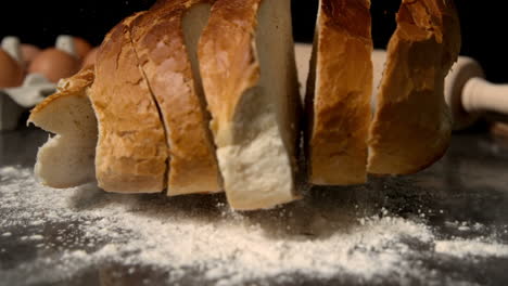 Sliced-loaf-of-bread-falling-on-flour-