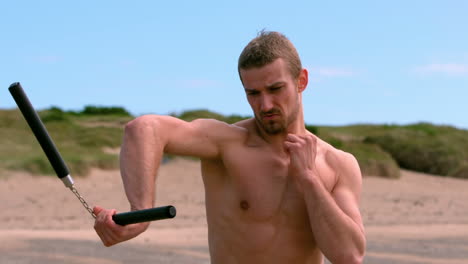 Martial-arts-expert-practicing-on-the-beach