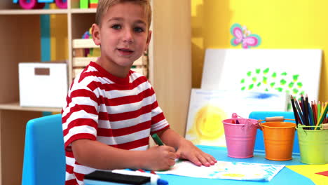 Cute-little-boy-colouring-in-classroom