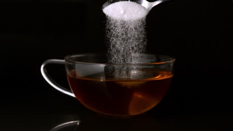 Teaspoon-pouring-sugar-into-cup-of-tea