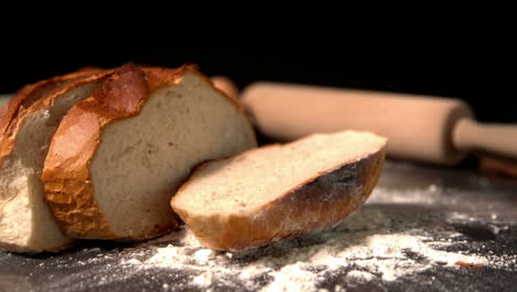 Sliced-loaf-of-bread-falling-on-flour-