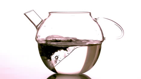 Teabag-falling-into-glass-teapot