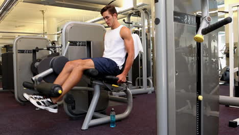 Fit-man-exercising-his-legs-on-weight-machine
