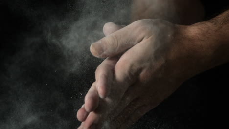 Bakers-hands-clapping-flour-off-on-black-background