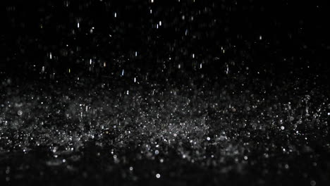 Rain-falling-on-black-surface