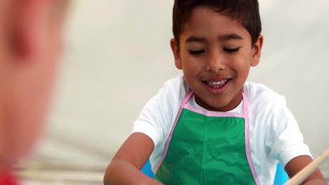 Cute-little-boys-painting-at-table-in-classroom