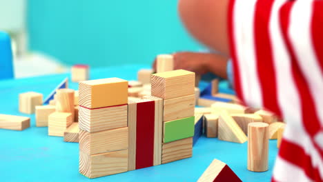 Cute-little-boys-playing-with-building-blocks-at-table