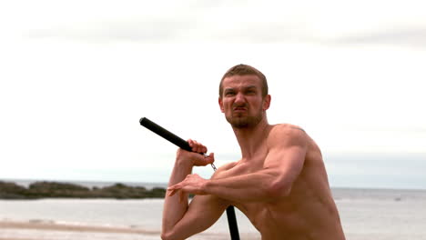 Martial-arts-expert-practicing-on-the-beach