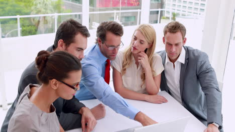 Business-people-working-together-at-meeting-on-laptop