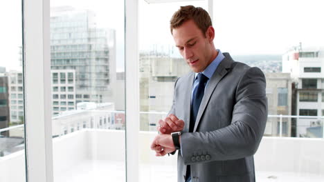 Handsome-businessman-using-his-smart-watch