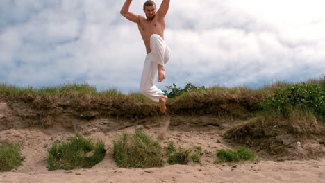 Martial-arts-expert-practicing-on-the-beach