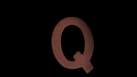 The-letter-q-rising-on-black-background