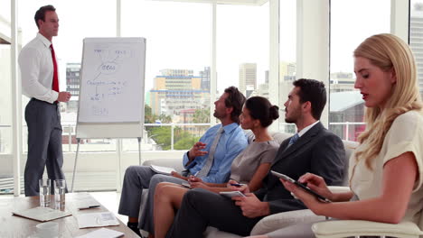 Business-team-listening-to-presentation