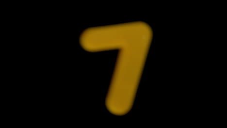 The-number-seven-coming-into-focus-on-black-background