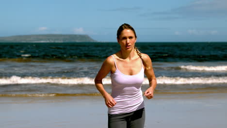 Fit-blonde-jogging-on-the-beach