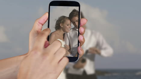 Hand-showing-wedding-clips-on-smartphone