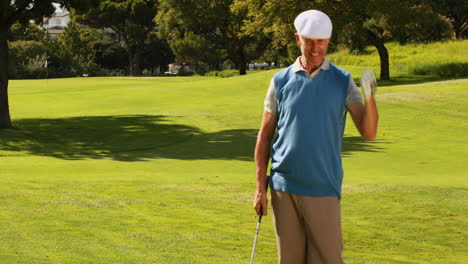 Man-celebrating-on-the-putting-green-of-golf-course