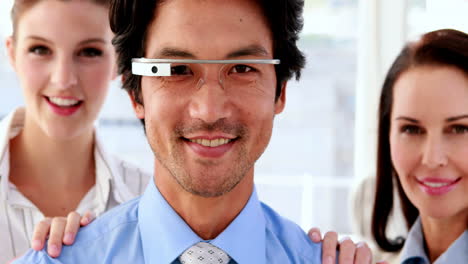 Businessman-smiling-at-camera-wearing-smart-glasses