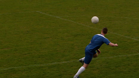Football-Spieler-In-Blau-Kickt-Den-Ball-Auf-Dem-Spielfeld