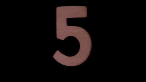 The-number-5-rising-on-black-background