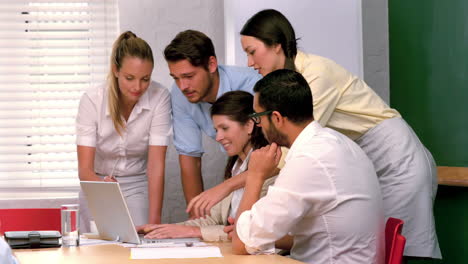 Business-team-having-a-meeting-with-laptop