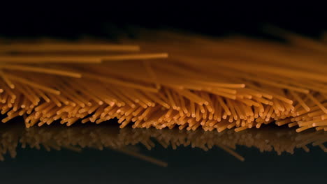 Spaghetti-pouring-onto-black-surface