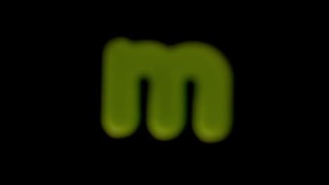 The-letter-m-coming-into-focus-on-black-background