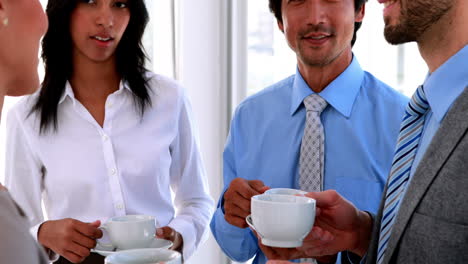 Business-team-having-coffee-and-chatting