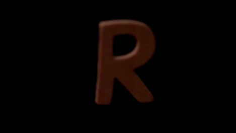 The-letter-r-rising-on-black-background