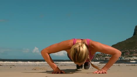 Fit-blonde-doing-push-ups-on-the-beach