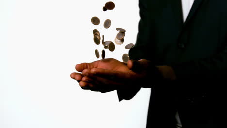 Businessman-catching-falling-coins-in-hands